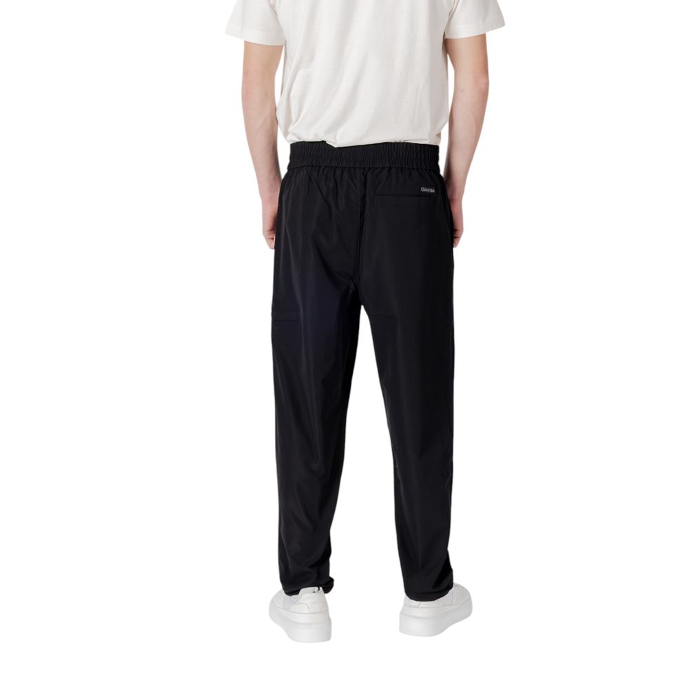 Black polyester casual pants by Calvin Klein Jeans, featuring a relaxed fit and classic design, suitable for everyday wear.