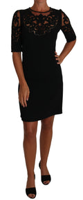 Dolce & Gabbana black floral cocktail dress with cut-out pattern, elegant design, and fitted silhouette.