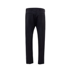 Valentino Garavani black wool dress pants with tailored fit and sleek design, shown on a hanger.