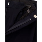 Black wool dress pants by Valentino Garavani, tailored fit with sleek style, shown on a hanger against a plain background.
