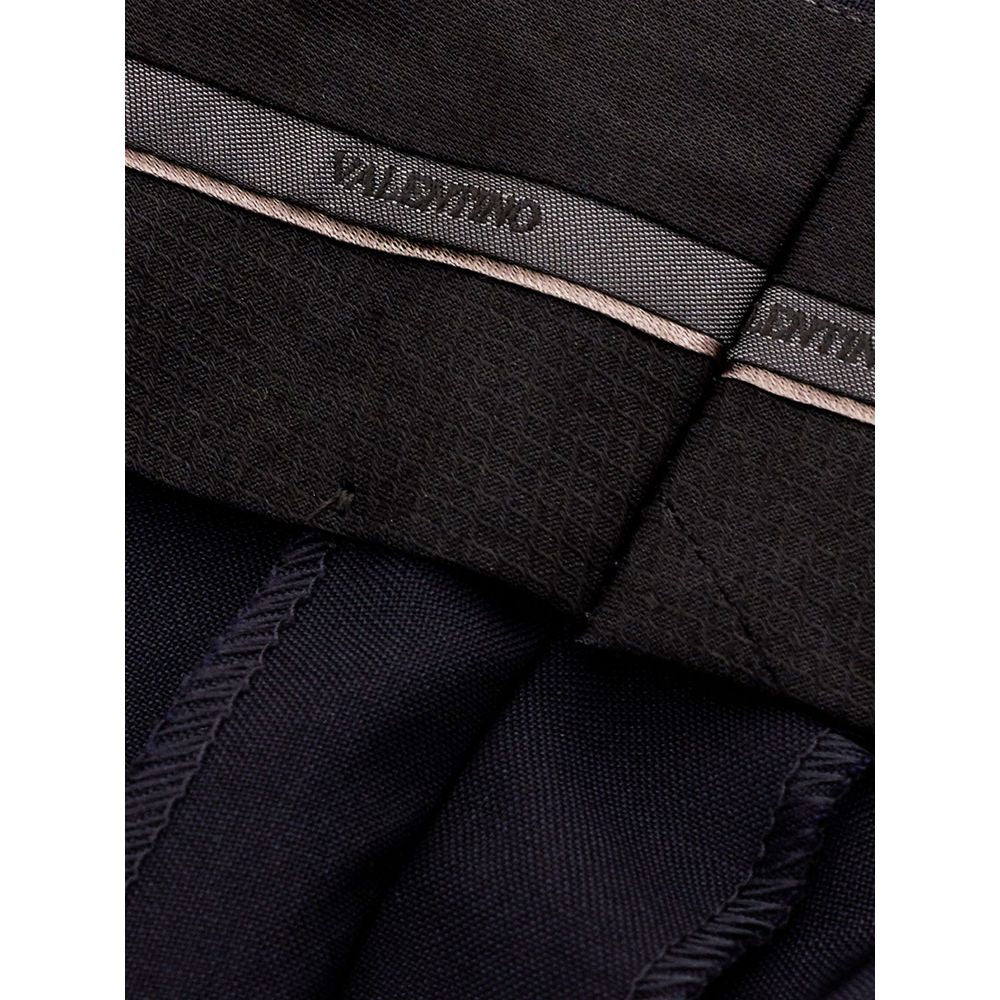 Black wool dress pants by Valentino Garavani, tailored with a sleek fit and classic style for formal or professional wear.