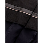 Black wool dress pants by Valentino Garavani, tailored with a sleek fit and classic style for formal or professional wear.