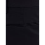 Valentino Garavani black wool dress pants displayed on a hanger, showcasing tailored fit and sleek design.