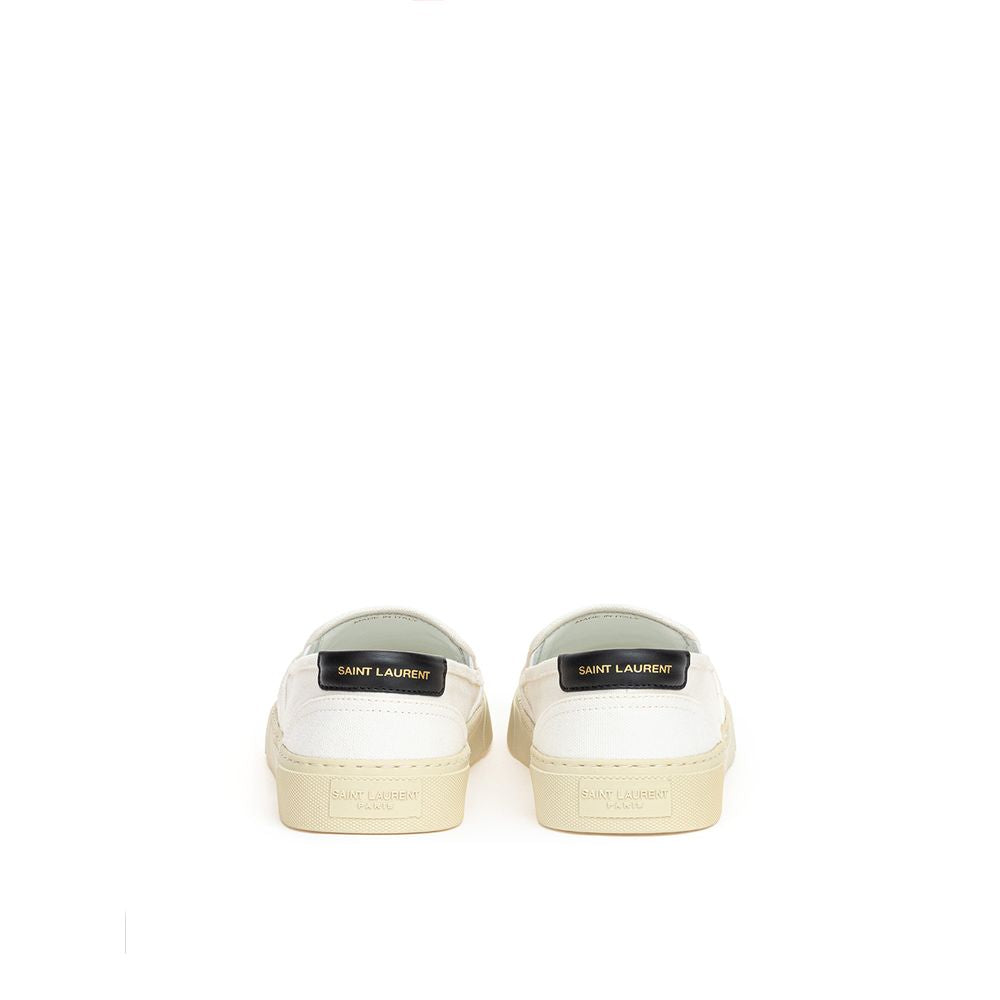 White cotton Saint Laurent low top sneakers with minimal design and clean laces, showcasing a stylish casual footwear option.