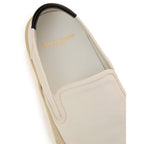 White Saint Laurent cotton low top sneakers with rounded toe and flat rubber sole, stylish casual footwear for men and women.