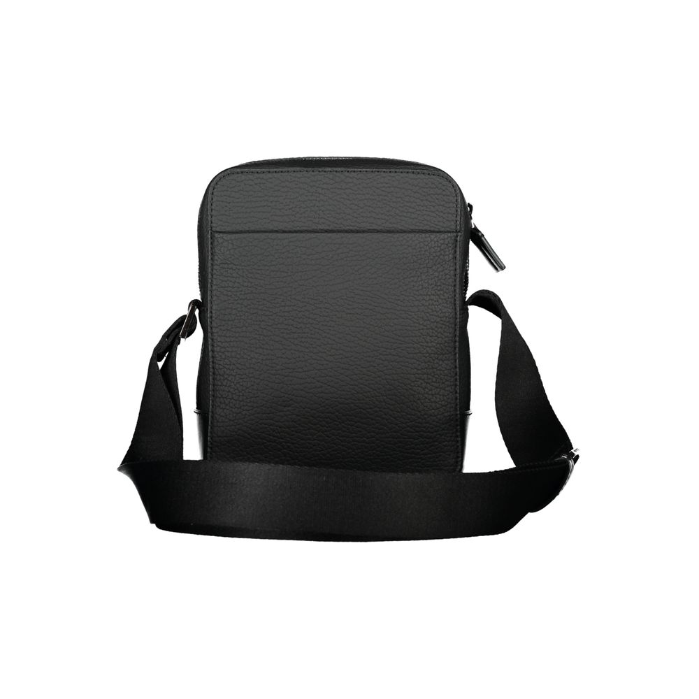 Calvin Klein sleek black shoulder bag with contrasting details, featuring a structured design and adjustable strap.