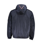 Tommy Hilfiger men's blue nylon jacket displayed on a hanger, featuring a zip front, collar, and brand logo details.