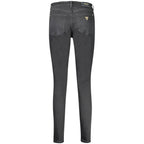 Black cotton women's skinny jeans by Guess Jeans, fitted style with classic five-pocket design and belt loops.