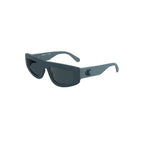 Calvin Klein Blue Bio Women sunglasses with round blue-tinted lenses and slim metal frame on a white background.