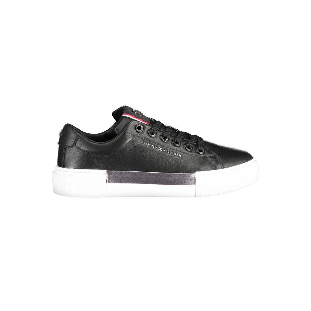 Black leather women's sneaker by Tommy Hilfiger with white sole and classic branding, stylish and comfortable footwear.
