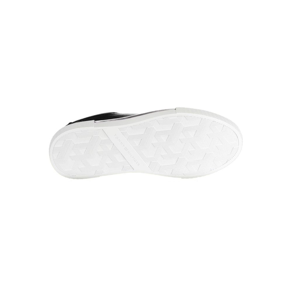 Black leather women's sneaker from Tommy Hilfiger with white sole and subtle branding, stylish and comfortable footwear.
