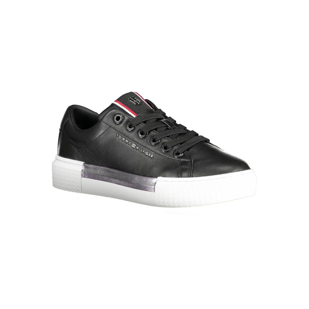 Black leather women's sneaker by Tommy Hilfiger with white sole and classic logo detail.