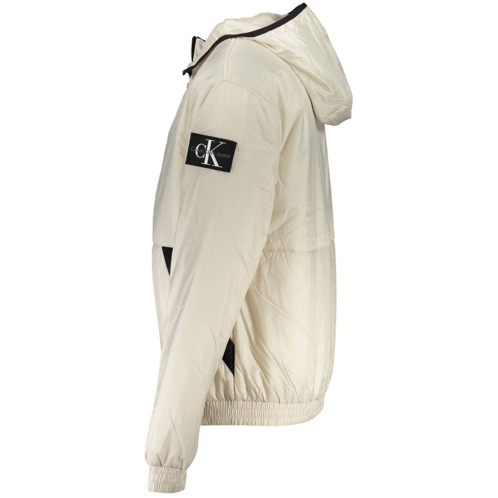 Calvin Klein beige recycled polyester men's jacket displayed on a hanger, showcasing its sleek design and fabric texture.