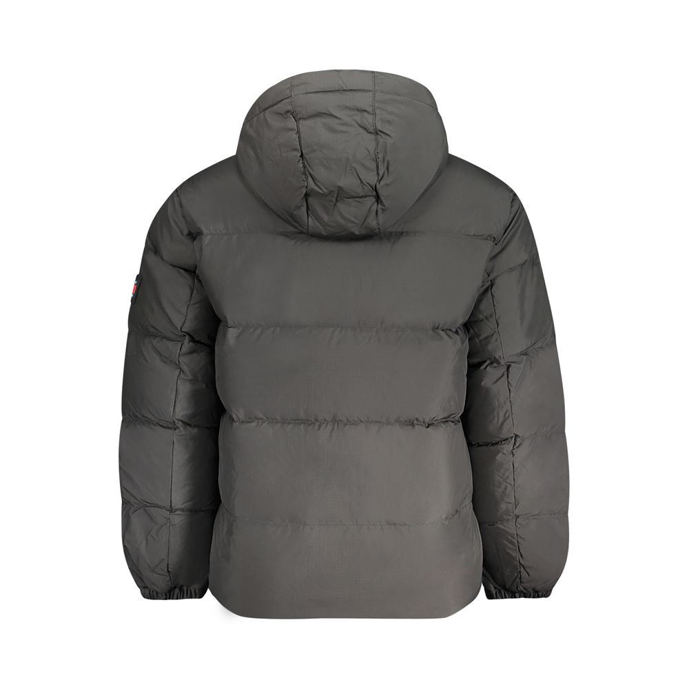 Tommy Hilfiger black men's polyester jacket displayed on a hanger with a front zipper and classic logo accents.