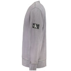 Calvin Klein gray cotton men's sweater displayed on a plain background, showing the classic crewneck design and soft fabric texture.