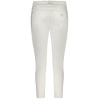 White cotton women's skinny jeans by Guess Jeans, close-up of the fitted denim pants with classic five-pocket design.