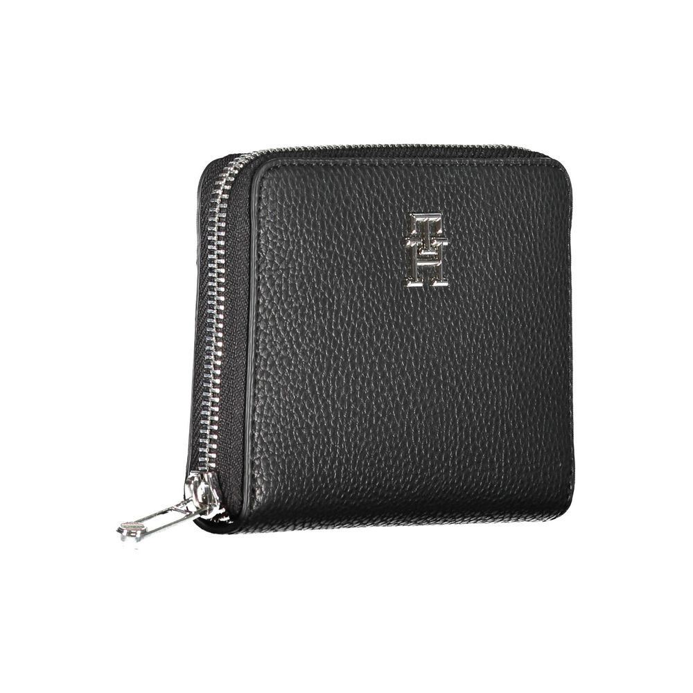 Tommy Hilfiger black polyurethane women's wallet with sleek design and multiple card slots, featuring the iconic logo.