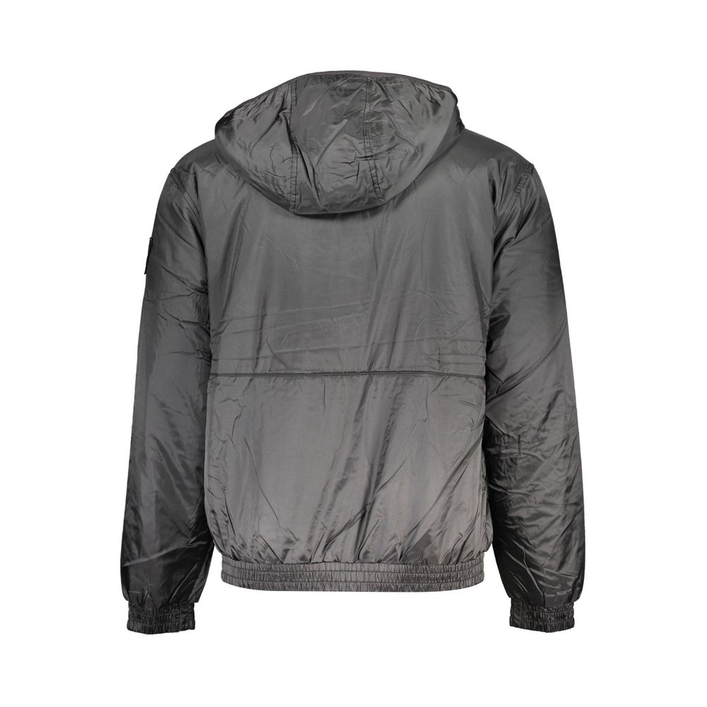 Calvin Klein black polyester men's jacket displayed on a hanger, showcasing its sleek design and modern style.
