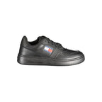 Black leather women's sneaker by Tommy Hilfiger featuring a sleek design and white sole detail.