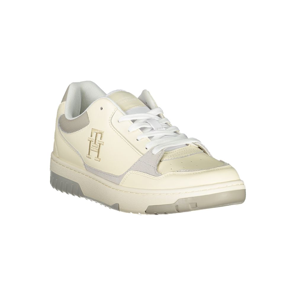 Tommy Hilfiger beige sports sneakers with unique embroidered details, featuring athletic design and casual style.