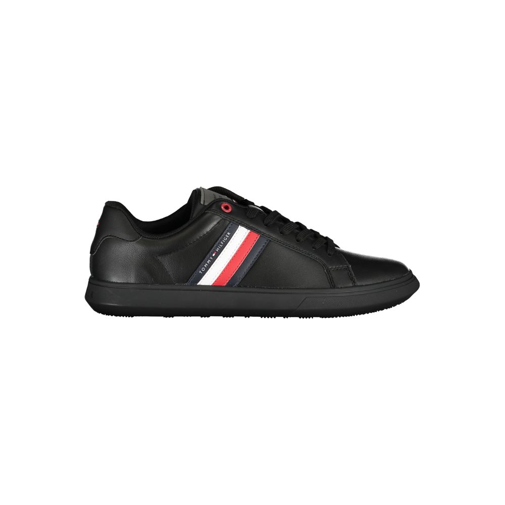 Black leather men's sneaker by Tommy Hilfiger featuring sleek design and signature branding, shown from a side angle.