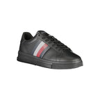 Tommy Hilfiger black polyurethane men's sneaker with white sole and brand logo detail on the side.