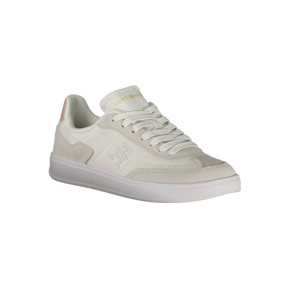 Tommy Hilfiger white polyurethane women's sneaker with sleek design and sporty style, shown from side view.