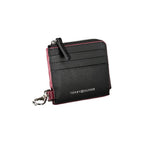 Black leather men's wallet holder by Tommy Hilfiger with sleek design and branded logo, suitable for everyday use.