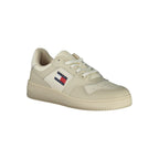 Tommy Hilfiger beige polyester athletic sneakers with white soles and laces, designed for sports and casual wear.
