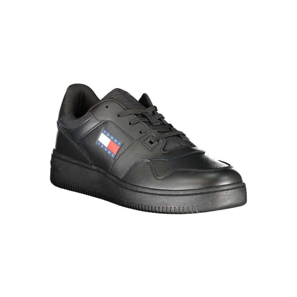 Tommy Hilfiger black leather men's sneaker with white sole and subtle branding, displayed on a plain background.