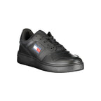 Tommy Hilfiger black leather men's sneaker with white sole and subtle branding, displayed on a plain background.