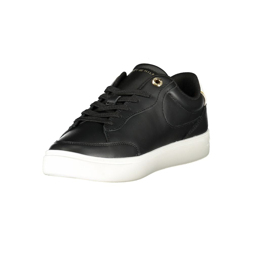 Black Tommy Hilfiger women’s sneaker with polyurethane upper and white sole, casual athletic shoe with logo details.