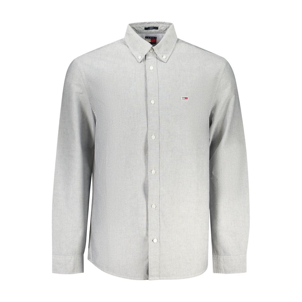 Tommy Hilfiger men's Grigio cotton shirt displayed on a hanger, featuring a classic button-up design and the iconic Tommy Hilfiger logo.