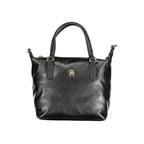 Tommy Hilfiger black polyester women's handbag with sleek design and silver hardware, featuring top handles and a spacious interior.