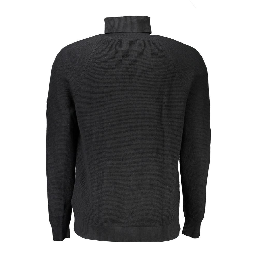 Black wool men's sweater by Calvin Klein featuring a classic crew neck and ribbed cuffs, styled on a plain background.