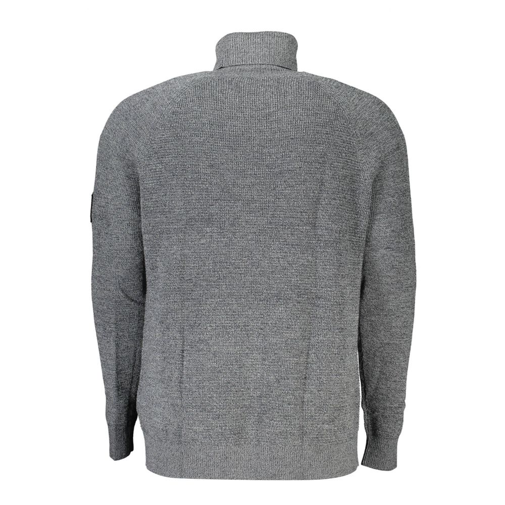 Calvin Klein Grigio wool men's sweater displayed on a hanger, featuring a classic crewneck design and textured knit fabric.