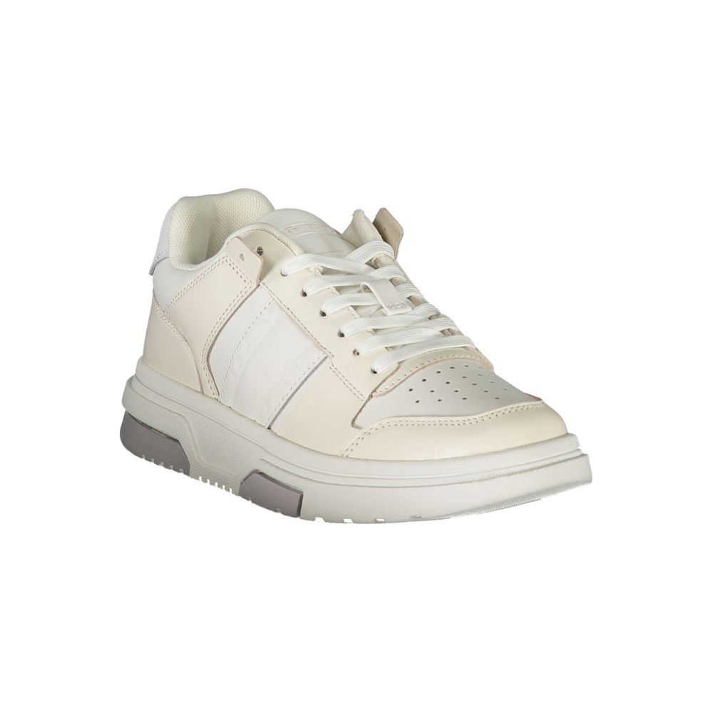 White leather Tommy Hilfiger women's sneaker with logo detail and stylish design, shown from a side view.