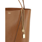 Chloé brown calf leather Bos Taurus shoulder bag with gold-tone hardware and adjustable strap, showcasing a stylish and elegant design.
