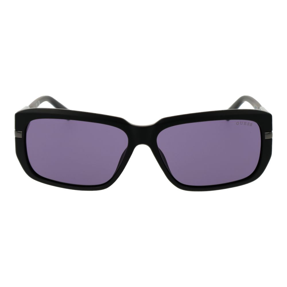 Guess black plastic sunglasses with rounded frames and dark lenses, stylish eyewear for sun protection.