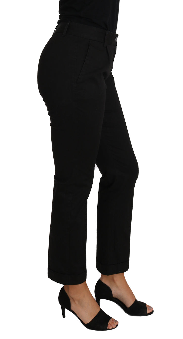 Dolce & Gabbana black dress and cropped straight pants ensemble displayed on a hanger with a neutral background.