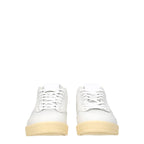 White leather low top sneakers by Jil Sander, featuring minimalistic design and clean stitching.