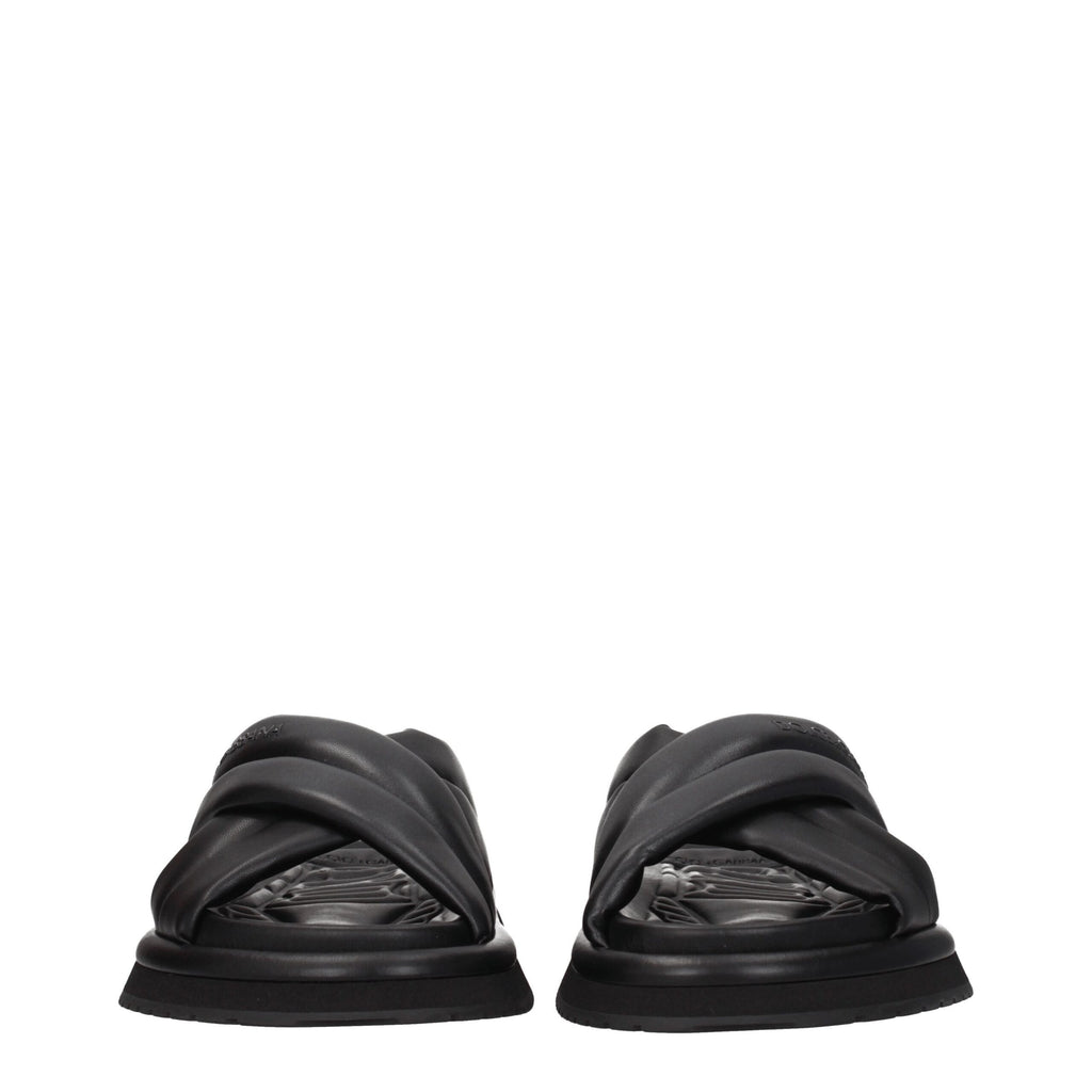 Black leather slippers from Dolce & Gabbana with sleek design and branded detailing, ideal for stylish casual wear.