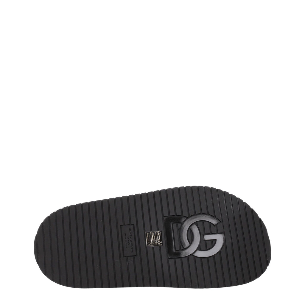 Black leather slippers from Dolce & Gabbana with a sleek design and subtle branding, perfect for stylish casual wear.