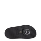 Black leather slippers from Dolce & Gabbana with a sleek design and subtle branding, perfect for stylish casual wear.