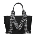 Black fabric shoulder bag by Marc Jacobs with adjustable strap and sleek design, perfect for casual or chic outfits.
