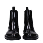 Black leather ankle boots by Dolce & Gabbana with sleek design and pointed toes, stylish footwear for sophisticated outfits.
