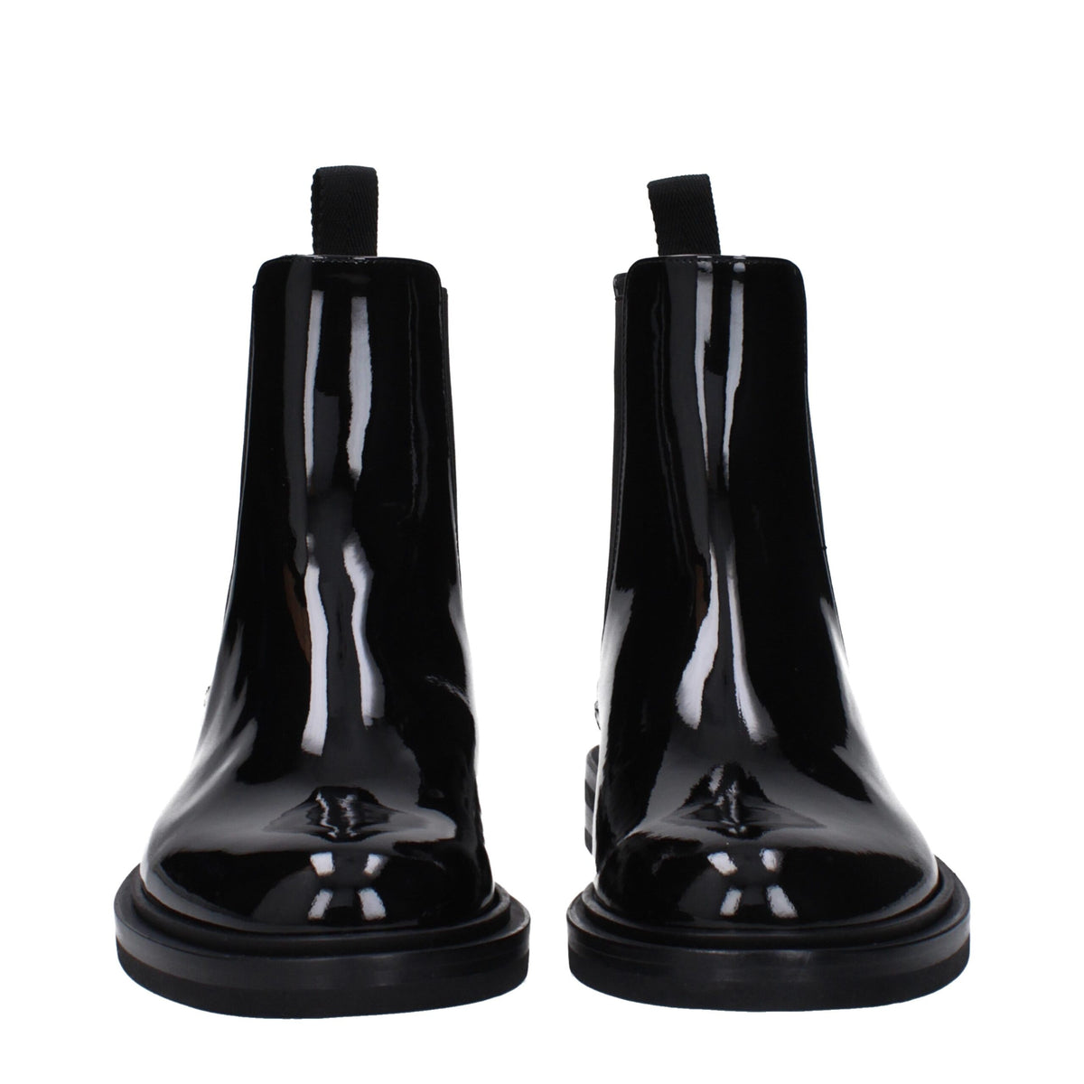 Black leather ankle boots by Dolce & Gabbana with sleek design and pointed toes, stylish footwear for sophisticated outfits.