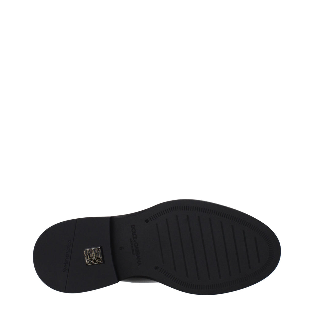 Dolce & Gabbana black leather ankle boots with sleek design and pointed toes, suitable for stylish everyday wear.
