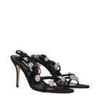 Manolo Blahnik black satin stiletto heel sandals with open toes and ankle straps, elegant and stylish footwear.