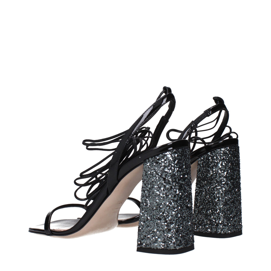 Black leather platform sandals by Miu Miu with chunky heels and open toes, featuring sleek straps and stylish design.